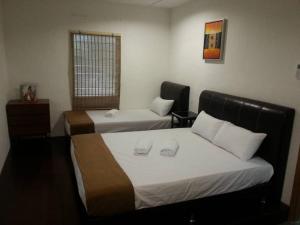 En eller flere senge i et værelse på Green Season Cottage