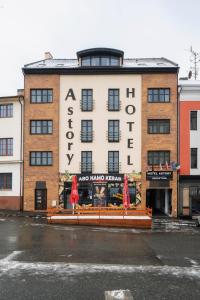 a building with a sign on the front of it at Hotel Astory Plzeň in Pilsen