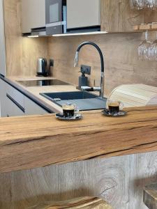 a kitchen with two cups of coffee on a counter at Penzion Pod Kaštanem in Nedakonitz