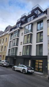 a white car parked in front of a building at Betariel Apartments M12 in Vienna