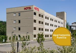 a hotel with a sign in front of a building at Slim Bento Gonçalves in Bento Gonçalves