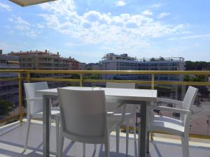 a white table and chairs on a balcony at Rentalmar Navarra family suites in Salou