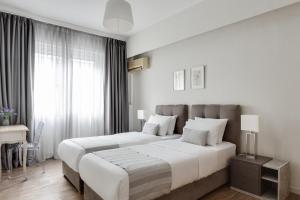 Syntagma Spotlight Residence tesisinde bir odada yatak veya yataklar