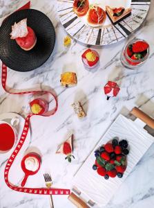 a white marble table with plates of food on it at Grand Millennium Shanghai HongQiao in Shanghai