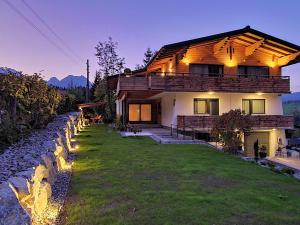 a house with a stone wall in front of it at Alpenhaus Donnerkogel in Annaberg im Lammertal