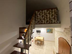 a staircase in a house with a table and a dining room at Casa Asia in Vieste