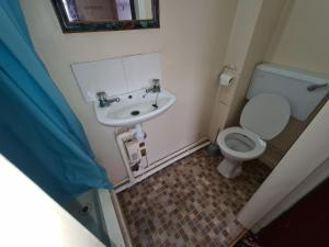 a bathroom with a toilet and a sink at The Coach House in Kegworth