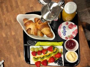 a tray of food with pastries and fruit on a table at The Overlook Bed and Breakfast in Glastonbury