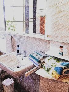 a bathroom with a sink and a mirror at Agriturismo bio Verde Armonia in Montemarciano