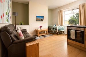 a living room with a couch and a table at Thornton Farm Cottages in Berwick-Upon-Tweed