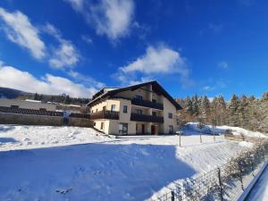 a house in the snow with a fence at Apartmány na Krásné Vyhlídce in Liberec