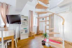 a living room with a spiral staircase and a desk at Luxury Villa Roza in Split