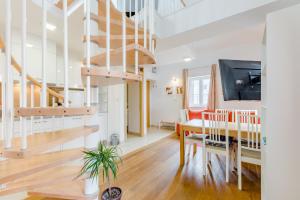 a dining room and living room with a spiral staircase at Luxury Villa Roza in Split +19 photos