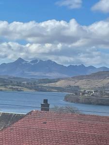 a view of a river with mountains in the background at Two bedroom house in central Portree in Portree