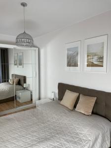 Postel nebo postele na pokoji v ubytování Apartament Kołobrzeg Kasprowicza + 4 fotografie