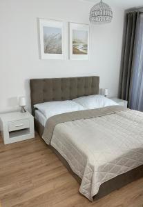 Postel nebo postele na pokoji v ubytování Apartament Kołobrzeg Kasprowicza
