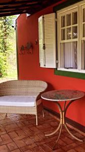 a room with a bench and a table and a window at Canyon Cascata Eco Parque in Capitólio