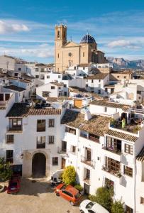 an overview of a city with white buildings and a church at Porta Nova Suites Altea - Adults Only in Altea