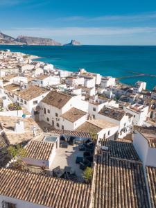 an aerial view of a town with white buildings and the ocean at Porta Nova Suites - Room Breakfast & Sea View in Altea +23 photos