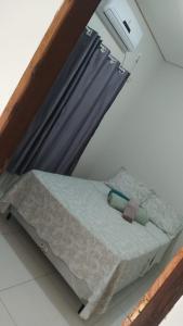 a bed with a mirror in a room at Casa de dois quartos in Carolina +3 photos