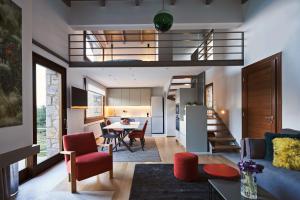 a living room and kitchen with a staircase in a house at Alti Parnassos in Amfiklia