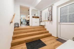 a staircase in a home with wooden floors and a window at Ferienappartement Kammhuberhof in Pruggern