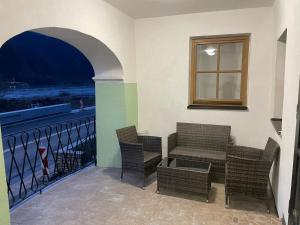 a balcony with chairs and a table and a window at HAUS-DONAU in der Wachau in Aggsbach