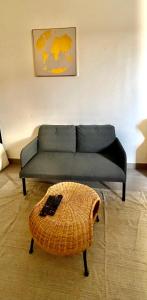 a couch and a ottoman in a living room at Magnifique studio in Bagnolet