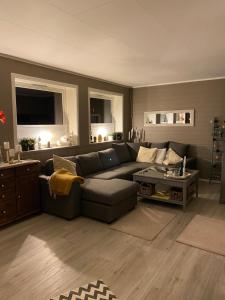 a living room with a couch and a table at Lyngen, Mackay appartment, Lyngen in Lyngseidet
