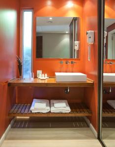 a bathroom with a sink and a mirror at Villa Isidro Hotel Boutique & Spa in San Isidro