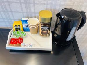 a small refrigerator with some food and a blender at ASHMINA HOLIDAY LET with Free onsite Parking for SMALL VANS and cars only in Milton Keynes