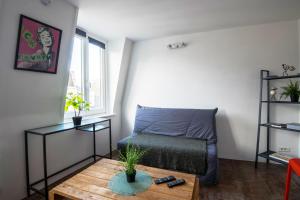 um pequeno quarto com uma cama e uma mesa em ROYALE APARTMENTS VIEUX LILLE 24H24H Access em Lille