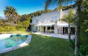 an exterior view of a house with a swimming pool at Villa Isidro Hotel Boutique & Spa in San Isidro