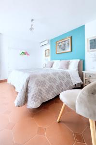 a bedroom with a large bed and a blue wall at Villa Lorelei in Massa Lubrense
