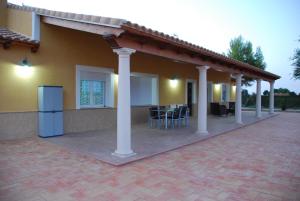 a house with a patio with tables and chairs at Casa Rural Tablas de Daimiel in Daimiel