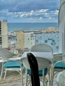 a balcony with chairs and a view of a harbor at SEA VIEW PARADISE 2 in Alexandria