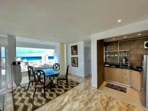 a dining room with a table and a kitchen at SEA VIEW PARADISE 2 in Alexandria
