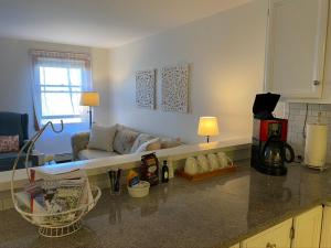 a kitchen with a living room with a couch at Victorian by the Sea in Lincolnville