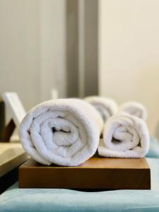 two rolled towels sitting on a cutting board at Palazzina300 in Treviso +227 photos