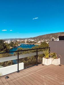 a balcony with a view of a body of water at Departamento frente al lago en Villa Carlos Paz in Villa Carlos Paz