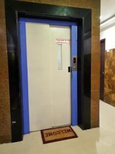 an elevator door in a building with a sign on it at BHIMAS INN -Puratchi Thalaivar Dr M G Ramachandran Central Railway Station Chennai in Chennai