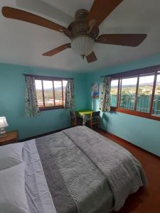 a bedroom with a bed and a ceiling fan at Casa Costa Rica Boutique B&B in Pilas