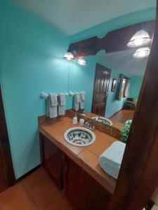 a bathroom with a sink and a large mirror at Casa Costa Rica Boutique B&B in Pilas