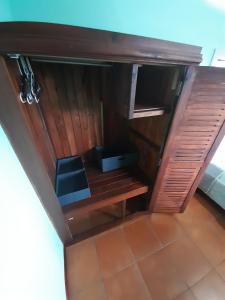 a wooden cabinet with a black seat in a room at Casa Costa Rica Boutique B&B in Pilas