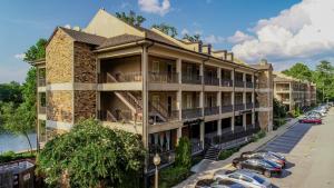 an apartment building with cars parked in a parking lot at Land of Oz in Tuscaloosa +22 photos