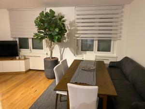 a living room with a table and a couch at Am Marktplatz Exklusives Appartement in Dornbirn