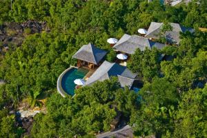 an aerial view of a resort with a pool and trees at Constance Ephelia in Port Glaud