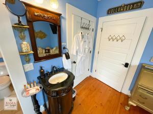 a bathroom with a sink and a mirror at Bama Bed and Breakfast - Chimes Suite in Tuscaloosa