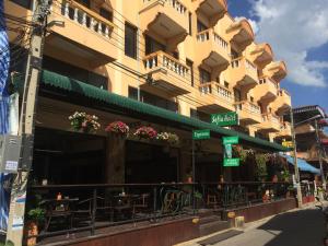 a building with a restaurant in front of it at Sofia Hotel in Hua Hin