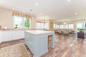 a large kitchen with white cabinets and a large island at Harmony Meadows Tennis Resort in Manson